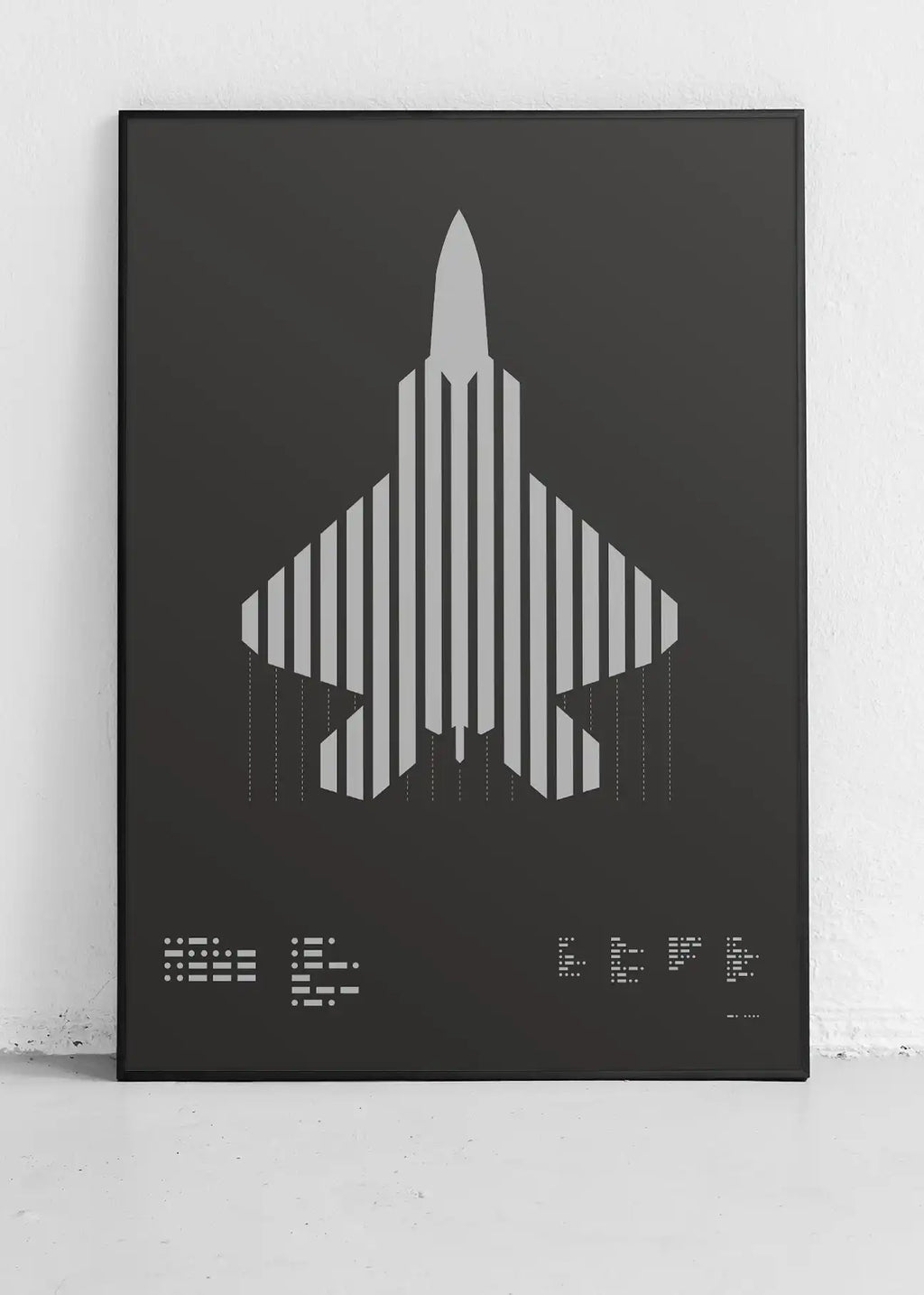 Framed minimalist artwork of the F-22 Raptor, featuring bold graphic lines and Morse code typography. Screenprinted in metallic silver ink, displayed in a modern home office setting.
