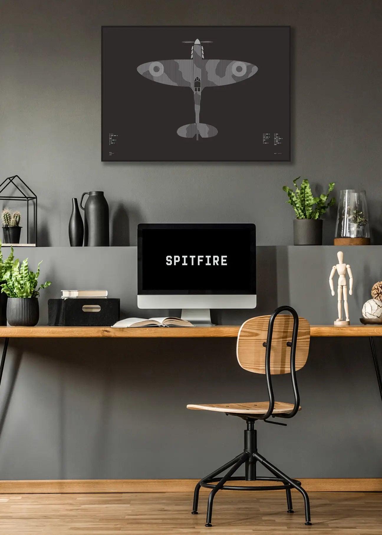 Minimalist artwork of the Spitfire aircraft, featuring bold graphic lines and Morse code typography. Screenprinted in metallic silver ink on premium Plike paper, displayed unframed in a modern home office setting.