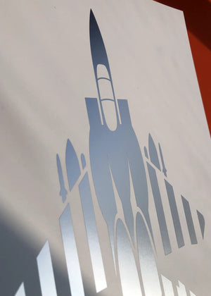Digital foil print of the F-15E Strike Eagle fighter jet, rendered in matt silver foil on white digital paper, with bold aerodynamic lines. Frame not included.