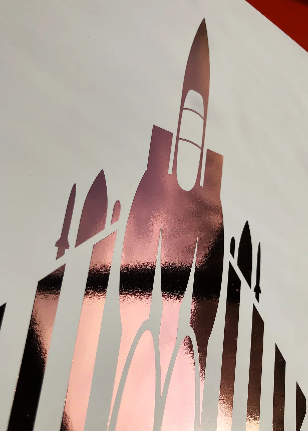 Digital foil aircraft print of the F-15E Strike Eagle air superiority fighter, rendered in rose gold foil on white digital paper, with bold aerodynamic lines. Frame not included.